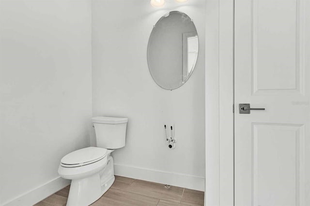 8007 Nevis Run, Bradenton, FL 34202 - half bathroom with baseboards, toilet, and wood finished floors
