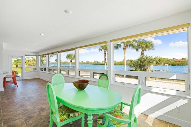 sunroom / solarium with a water view