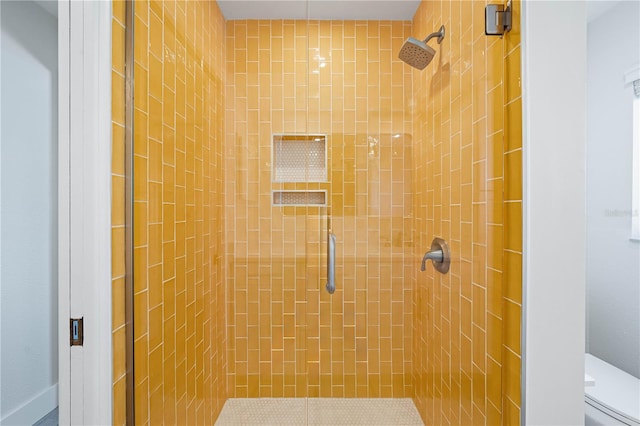 bathroom featuring toilet and walk in shower