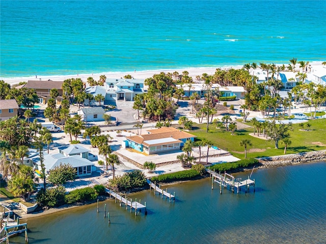 drone / aerial view with a water view and a view of the beach