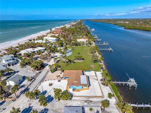 drone / aerial view featuring a water view and a view of the beach