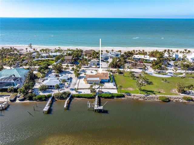 bird's eye view featuring a water view and a beach view