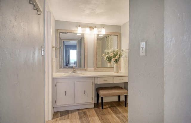 bathroom with hardwood / wood-style floors and vanity