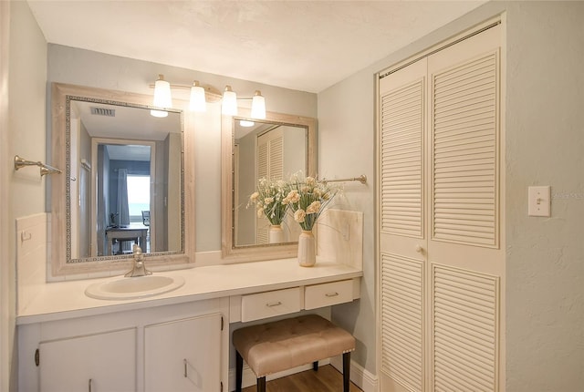 bathroom featuring vanity and wood-type flooring