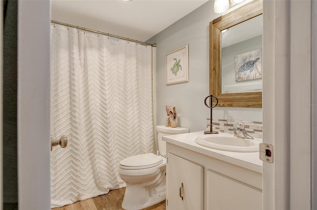 bathroom featuring hardwood / wood-style floors, vanity, and toilet