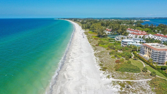 birds eye view of property featuring a water view and a beach view