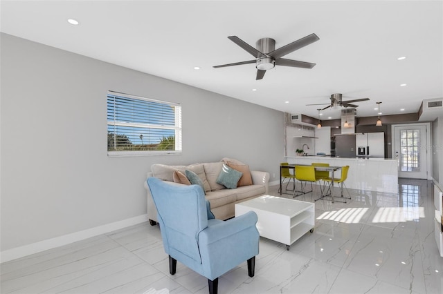 living room with plenty of natural light and ceiling fan