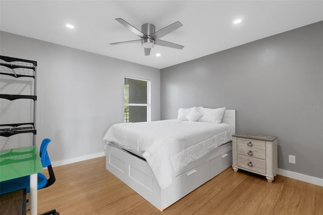 bedroom with ceiling fan and light hardwood / wood-style flooring