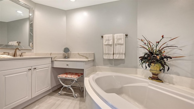 bathroom with vanity and a tub