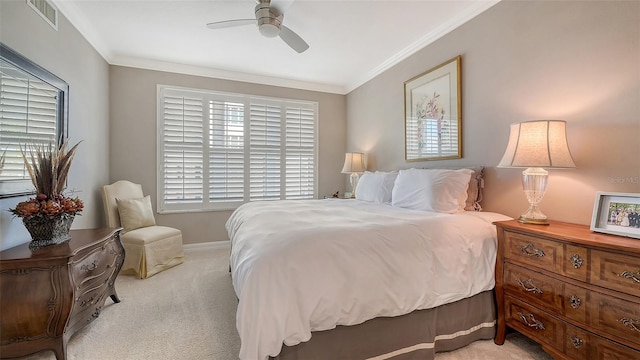 bedroom featuring ceiling fan, light colored carpet, and crown molding