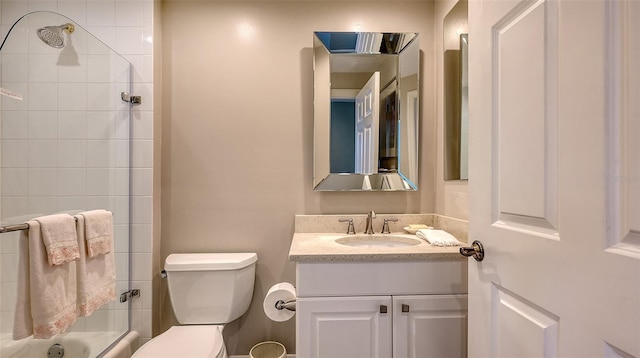 full bathroom featuring tiled shower / bath combo, toilet, and vanity