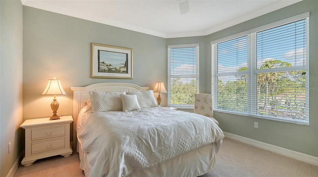 carpeted bedroom featuring ceiling fan and ornamental molding