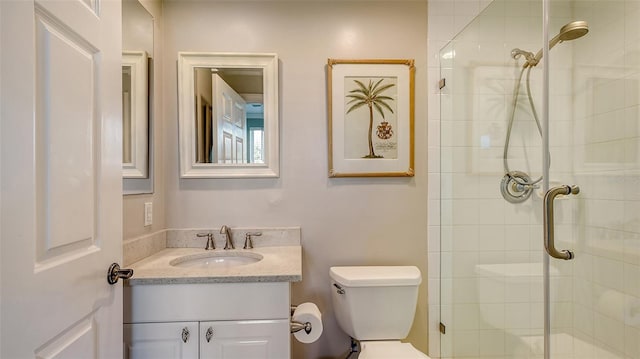 bathroom featuring toilet, vanity, and walk in shower