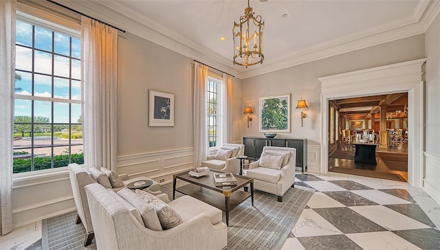 sitting room featuring a notable chandelier, a healthy amount of sunlight, and ornamental molding