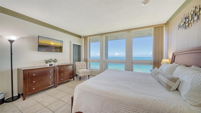 bedroom featuring light tile patterned floors, a textured ceiling, and crown molding