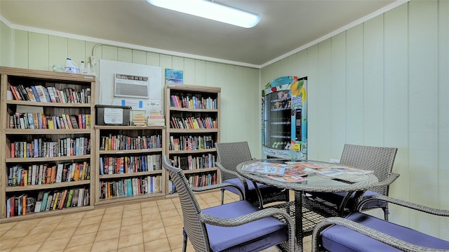 interior space with a wall unit AC, light tile patterned floors, crown molding, and wooden walls