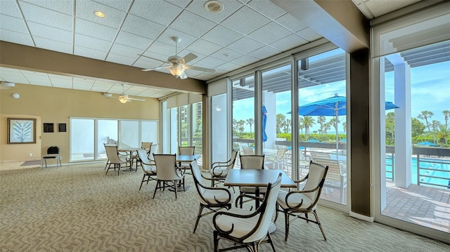 sunroom featuring ceiling fan