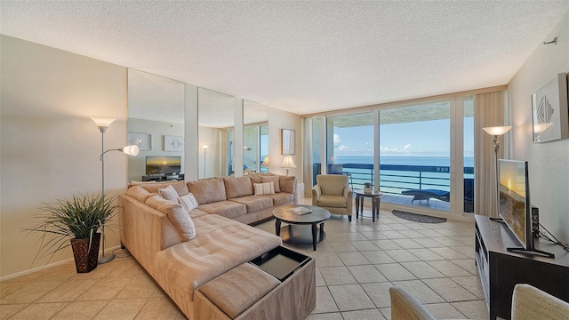 tiled living room featuring expansive windows and a textured ceiling