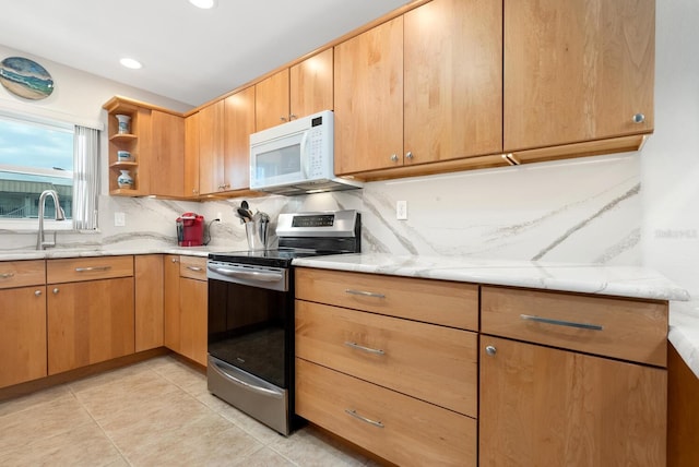 kitchen with electric stove, sink, light tile patterned floors, light stone counters, and tasteful backsplash