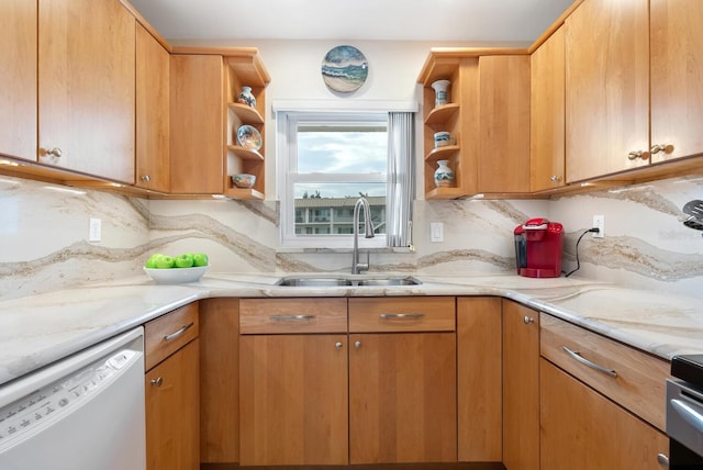 kitchen featuring sink, dishwasher, light stone countertops, and tasteful backsplash