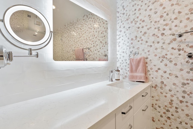 bathroom with vanity and decorative backsplash