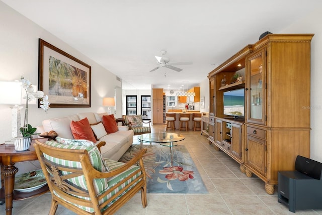 tiled living room with ceiling fan