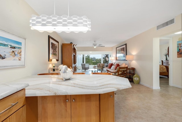 kitchen with ceiling fan, light tile patterned floors, and kitchen peninsula