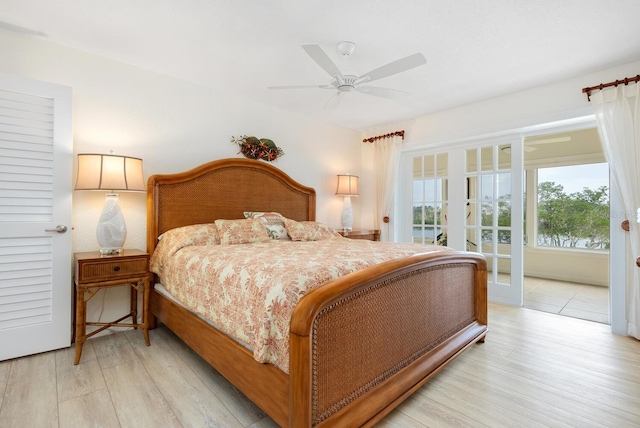 bedroom with light wood-type flooring, ceiling fan, and access to exterior