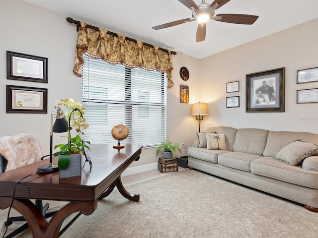 office area with a ceiling fan and baseboards