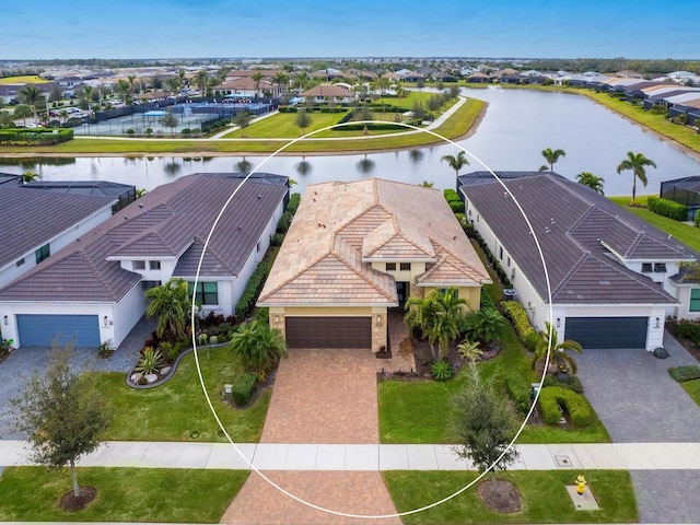 drone / aerial view featuring a residential view and a water view