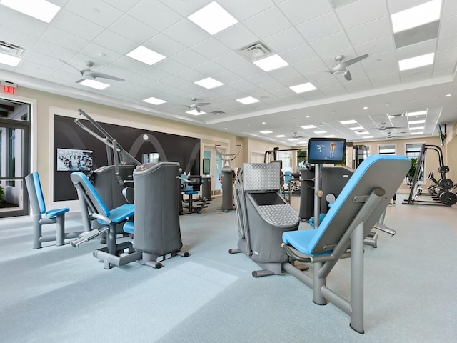 workout area with a ceiling fan, visible vents, and a drop ceiling