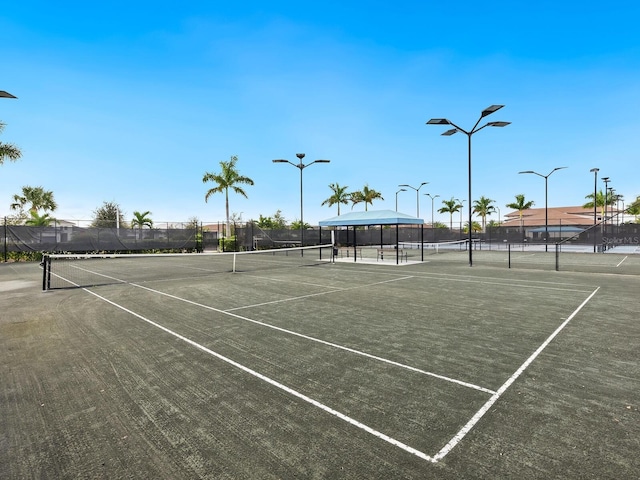 view of sport court featuring fence