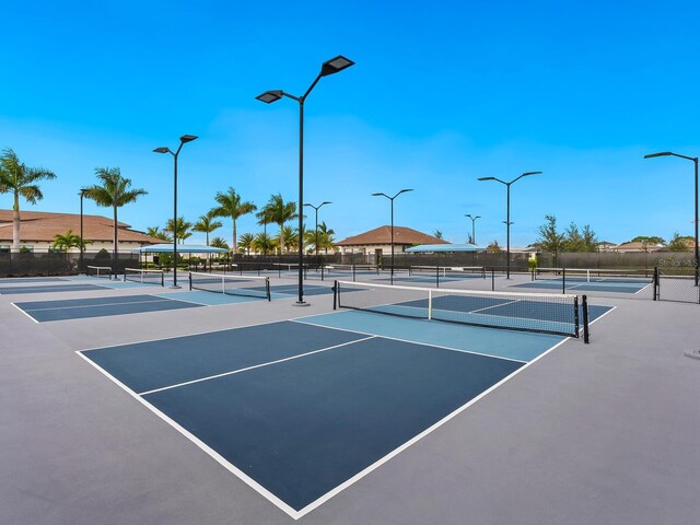 view of tennis court featuring fence