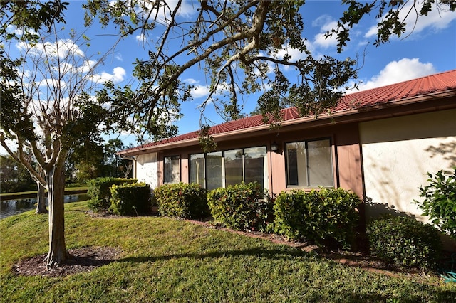 view of property exterior with a lawn