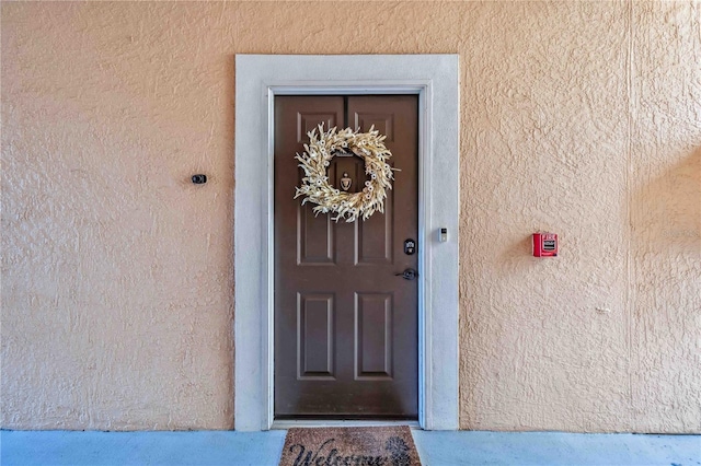 property entrance featuring stucco siding