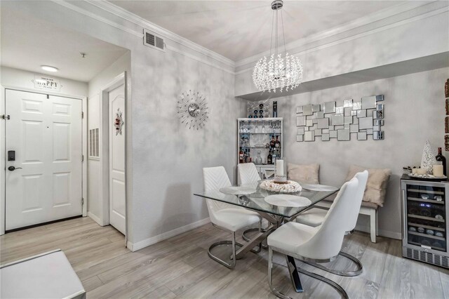 4106 Central Sarasota Pkwy Unit 1013, Sarasota, FL 34238 - dining room featuring wine cooler, a chandelier, wood finished floors, and crown molding