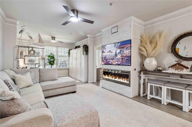 4106 Central Sarasota Pkwy Unit 1013, Sarasota, FL 34238 - living area with ornamental molding, a stone fireplace, ceiling fan, and wood finished floors
