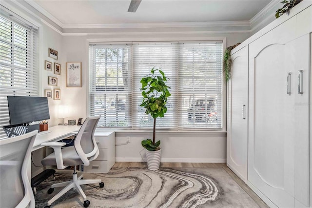 home office with light wood finished floors, ornamental molding, and baseboards