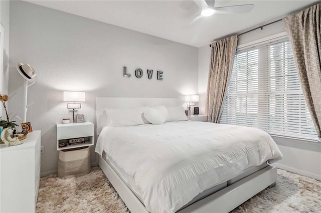 bedroom with a ceiling fan and baseboards