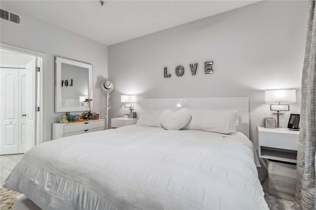 bedroom featuring light wood finished floors and visible vents