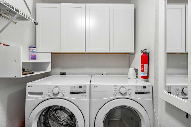 laundry room featuring washing machine and dryer and cabinet space