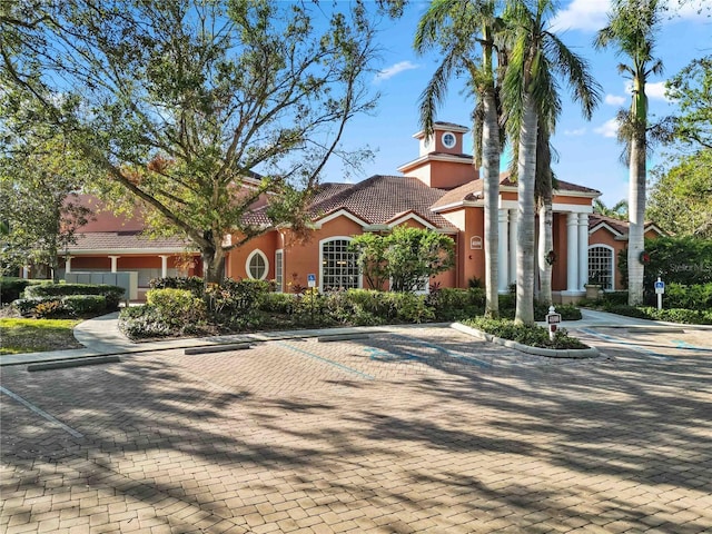 view of front of property with a tile roof and stucco siding