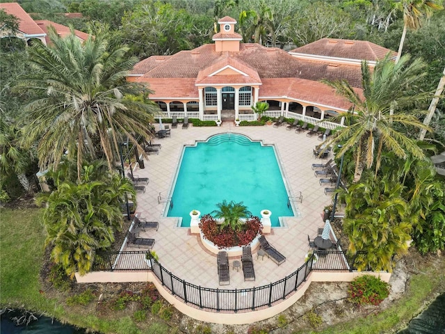 pool with fence and a patio