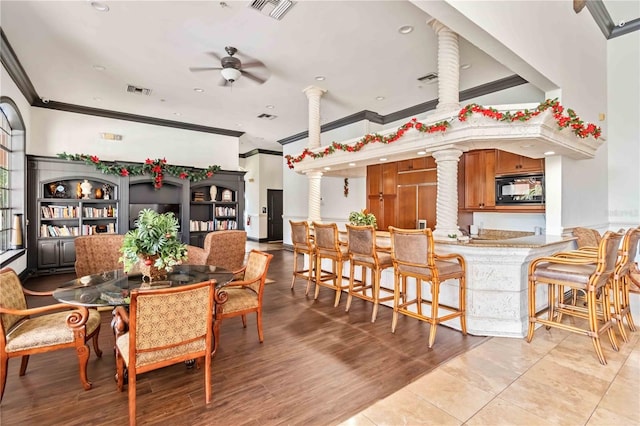 4106 Central Sarasota Pkwy Unit 1013, Sarasota, FL 34238 - dining room featuring crown molding, ceiling fan, decorative columns, and light wood finished floors
