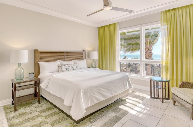 tiled bedroom with ceiling fan and crown molding