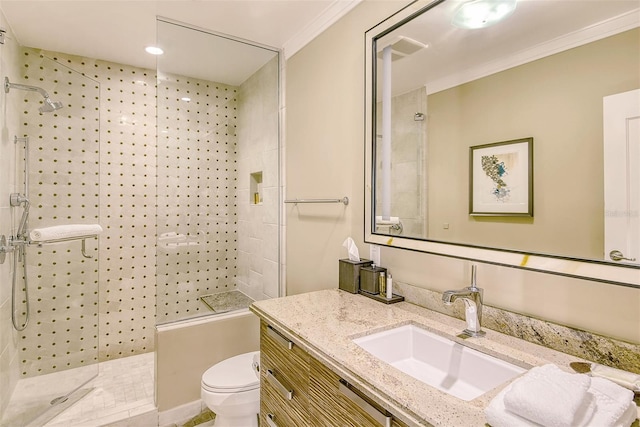 bathroom featuring tile patterned floors, crown molding, toilet, tiled shower, and vanity