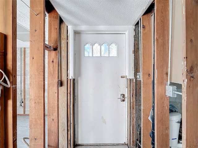 doorway with a textured ceiling