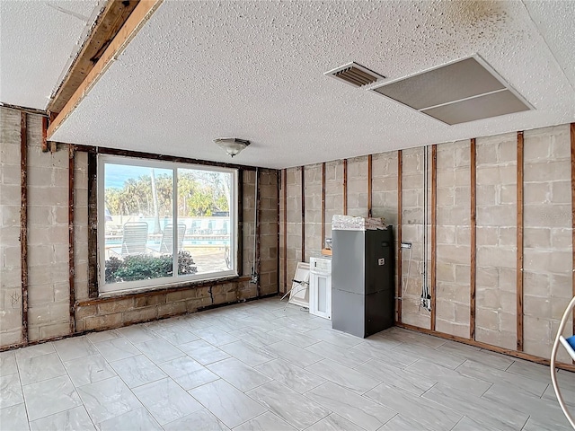 basement featuring a textured ceiling