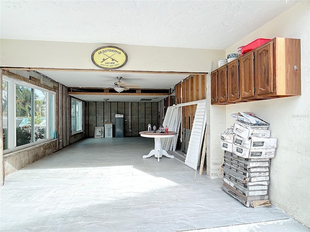 interior space with ceiling fan