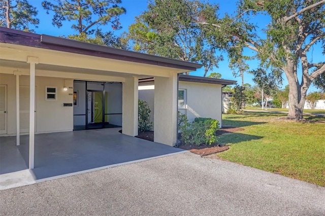 exterior space featuring a yard and a carport